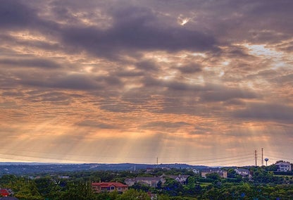 Sunlight breaking through clouds above Bee Cave, Texas